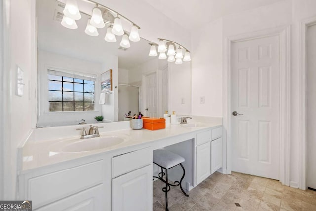 bathroom with a shower with shower door and vanity