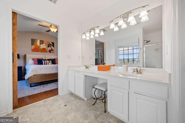 bathroom with vanity, ceiling fan, and an enclosed shower