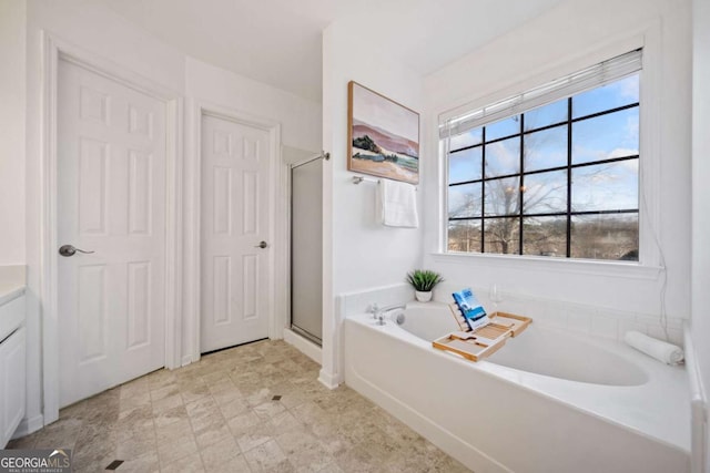 bathroom featuring vanity and plus walk in shower