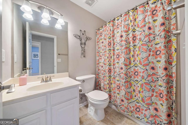 bathroom with toilet, vanity, and a shower with shower curtain