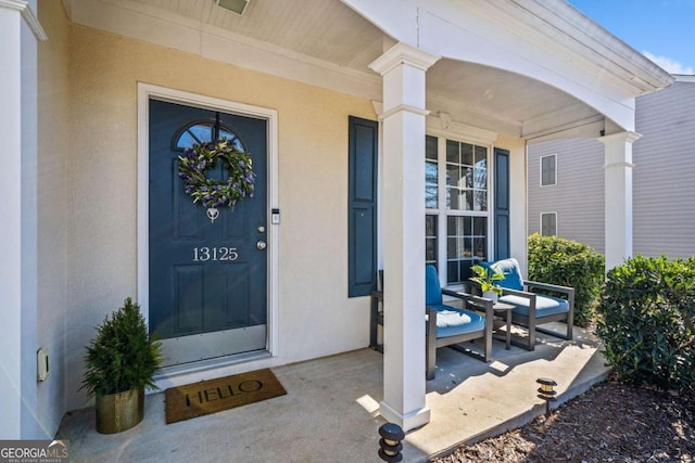 entrance to property featuring covered porch