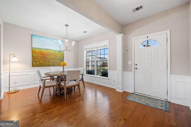 foyer with wood-type flooring and an inviting chandelier