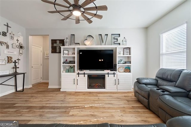 living room featuring ceiling fan and hardwood / wood-style floors