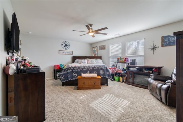 bedroom featuring ceiling fan and light colored carpet