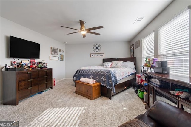 bedroom featuring light carpet and ceiling fan