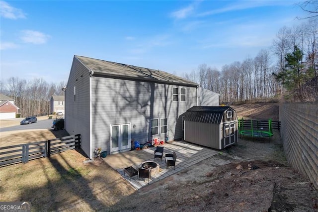 exterior space with a patio area, a storage unit, and a fire pit