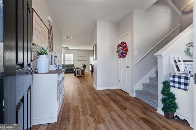 foyer with dark hardwood / wood-style floors and a fireplace