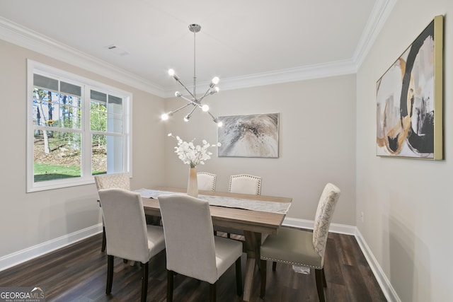 dining area featuring dark hardwood / wood-style flooring, ornamental molding, and an inviting chandelier