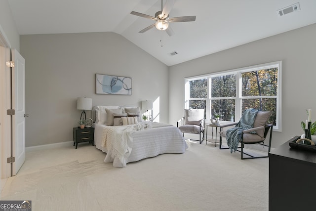 carpeted bedroom with ceiling fan and vaulted ceiling