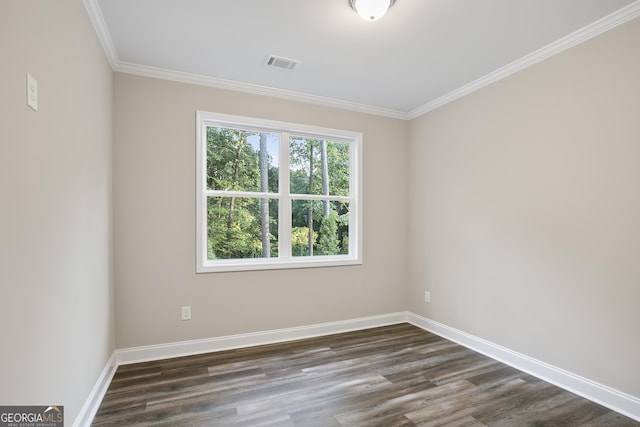 spare room with ornamental molding and dark hardwood / wood-style flooring