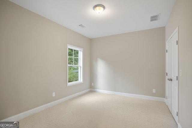 empty room featuring light carpet