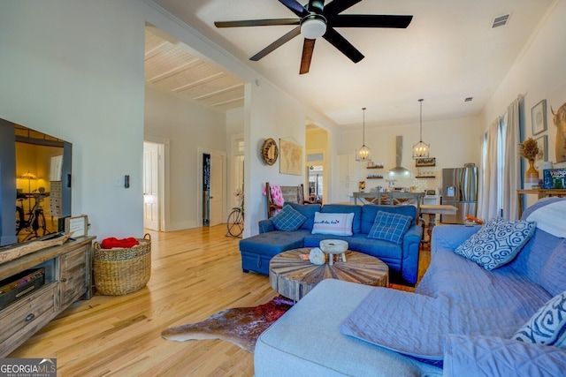 living room featuring light wood-type flooring and ceiling fan