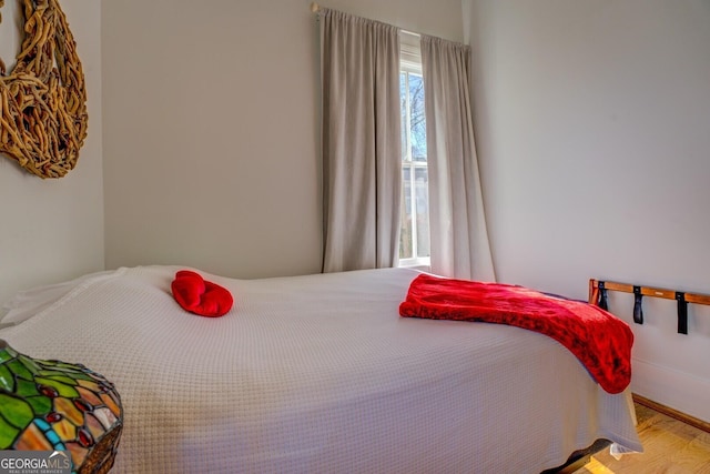 bedroom with hardwood / wood-style floors