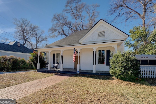 view of front of house with a front yard and a porch