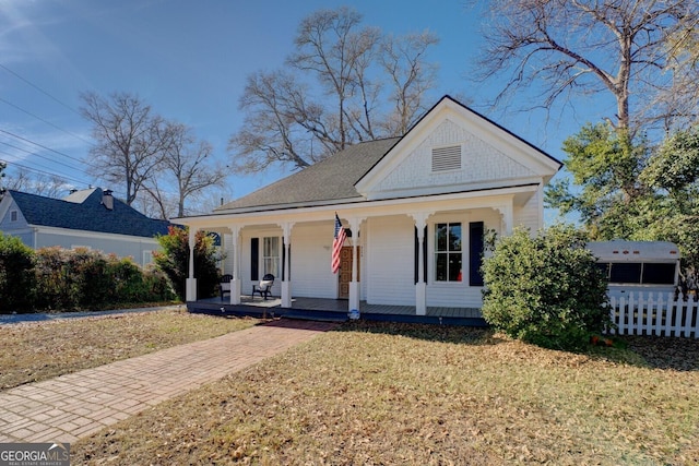 view of front of property with a front yard and a porch