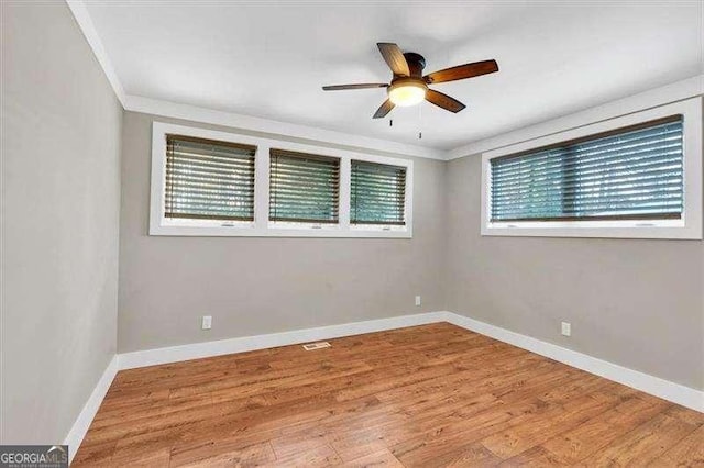 spare room with ceiling fan, ornamental molding, and hardwood / wood-style flooring