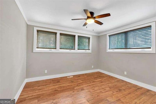 walk in closet with light wood finished floors