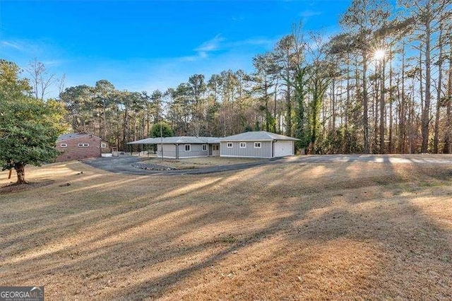 view of front of house with a front lawn and a carport