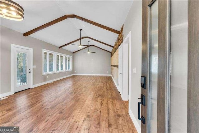 unfurnished living room featuring ceiling fan, vaulted ceiling with beams, and light hardwood / wood-style flooring