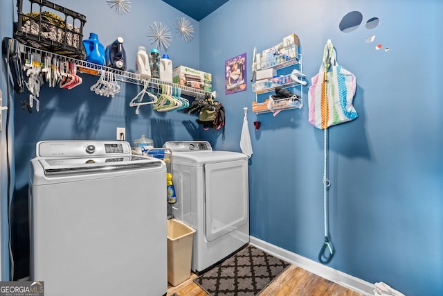 washroom with light hardwood / wood-style floors and independent washer and dryer