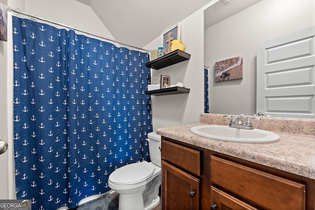 bathroom with lofted ceiling, vanity, toilet, and curtained shower