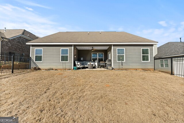 rear view of property with an outdoor hangout area, ceiling fan, a patio area, and a lawn