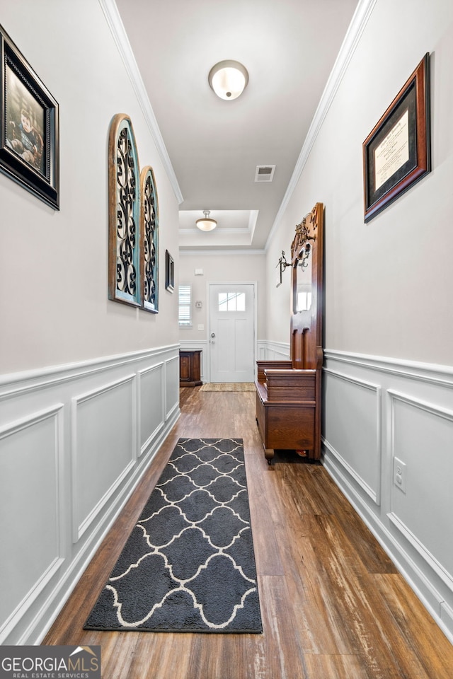 hall with dark hardwood / wood-style floors and crown molding