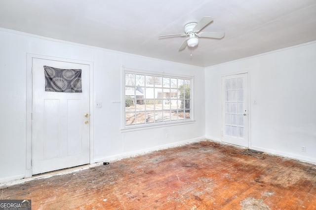 foyer with ceiling fan and crown molding