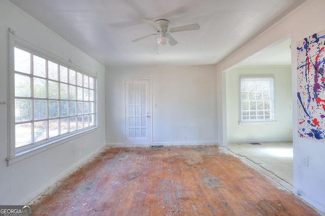 spare room featuring ceiling fan and ornamental molding