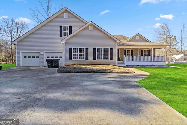 view of front of property with a garage, a front yard, and a porch