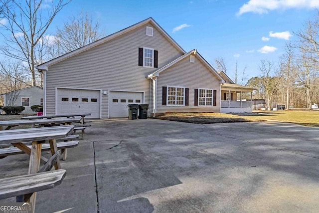 view of side of property with a garage and a porch