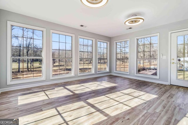 unfurnished sunroom with plenty of natural light