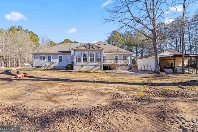 back of property featuring a wooden deck