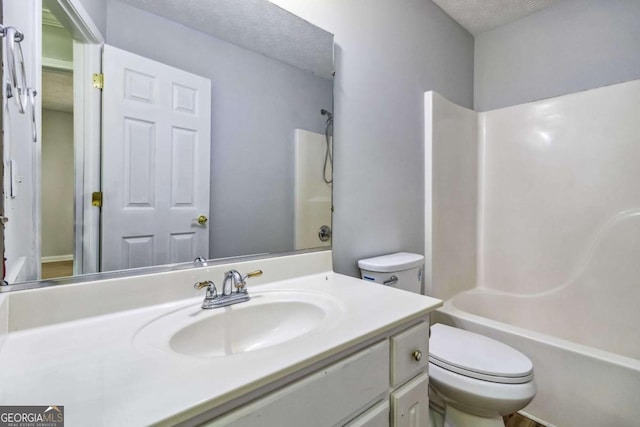 full bathroom with a textured ceiling, toilet, shower / bath combination, and vanity