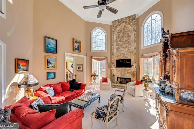 carpeted living room with a towering ceiling, a wealth of natural light, and a stone fireplace