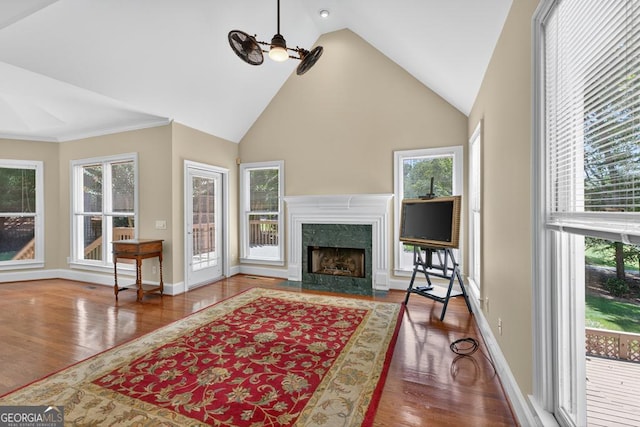 4225 Dunham Park, Flowery Branch, GA 30542 - living area with wood finished floors, ceiling fan, healthy amount of natural light, a fireplace, and high vaulted ceiling