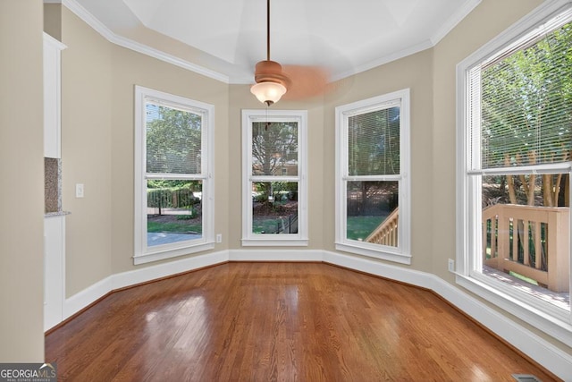 4225 Dunham Park, Flowery Branch, GA 30542 - unfurnished dining area featuring wood finished floors, crown molding, and a ceiling fan