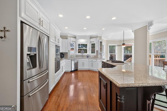 4225 Dunham Park, Flowery Branch, GA 30542 - kitchen featuring stainless steel appliances, ornamental molding, white cabinets, decorative backsplash, and recessed lighting