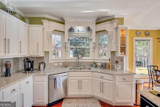 kitchen with white cabinetry, dishwasher, light stone counters, and sink