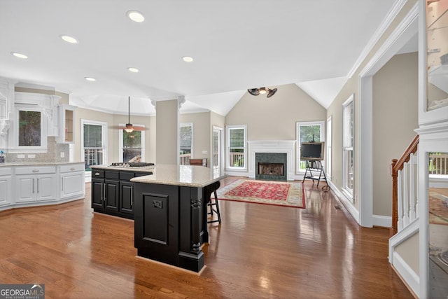 4225 Dunham Park, Flowery Branch, GA 30542 - kitchen with a center island, a fireplace, white cabinets, healthy amount of natural light, and recessed lighting