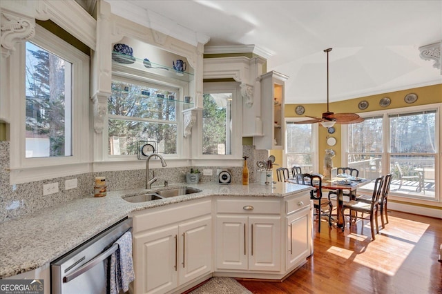 kitchen with white cabinetry, ceiling fan, dishwasher, hanging light fixtures, and sink