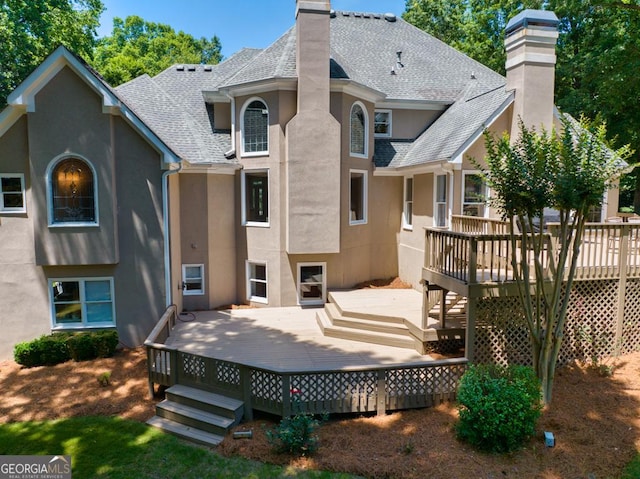 4225 Dunham Park, Flowery Branch, GA 30542 - rear view of property with a chimney, roof with shingles, stucco siding, and a wooden deck