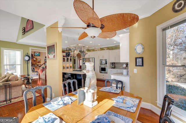 dining room featuring ceiling fan, dark wood-type flooring, and ornamental molding