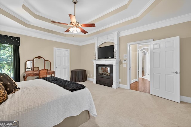 4225 Dunham Park, Flowery Branch, GA 30542 - bedroom with a tray ceiling, ornamental molding, light colored carpet, a large fireplace, and ceiling fan