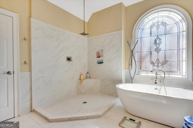 bathroom featuring a wealth of natural light, separate shower and tub, and vaulted ceiling