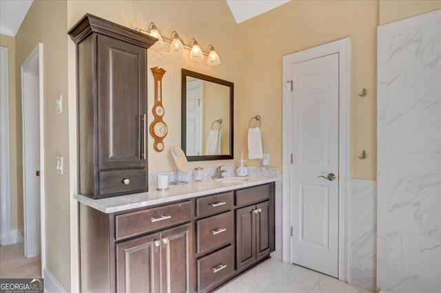 bathroom with ornamental molding and vanity