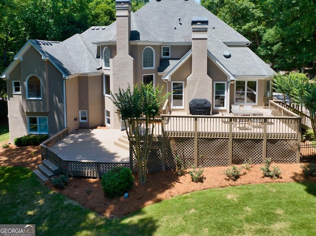 4225 Dunham Park, Flowery Branch, GA 30542 - rear view of property featuring a chimney, a shingled roof, stucco siding, and a wooden deck