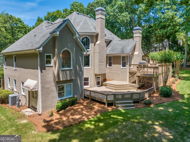 4225 Dunham Park, Flowery Branch, GA 30542 - rear view of property with stucco siding, a chimney, roof with shingles, a wooden deck, and a lawn