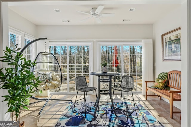 sunroom / solarium with ceiling fan and a wealth of natural light