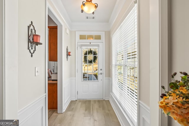 entryway featuring light wood-type flooring and crown molding